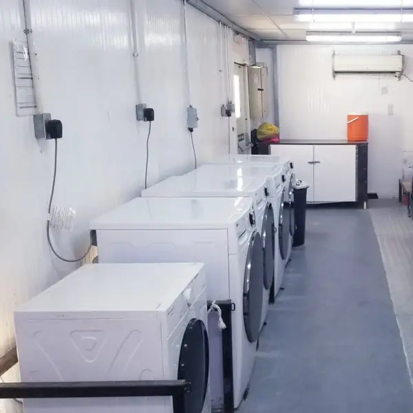 Camp laundry room lined with washing machines