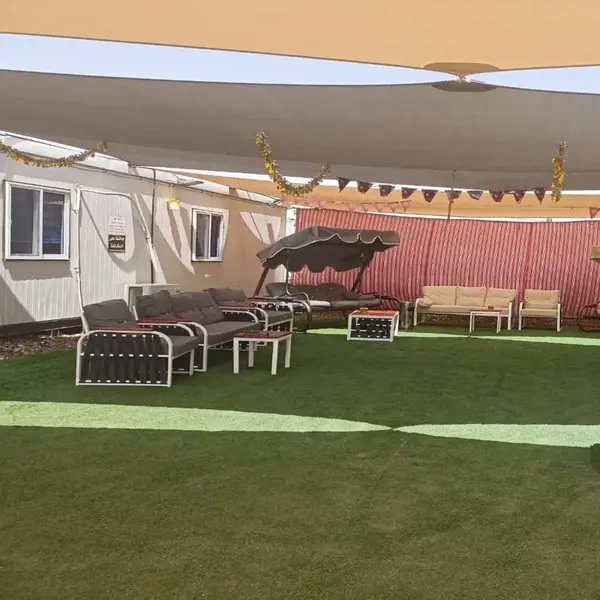 Shaded outdoor seating area beside the accommodation units